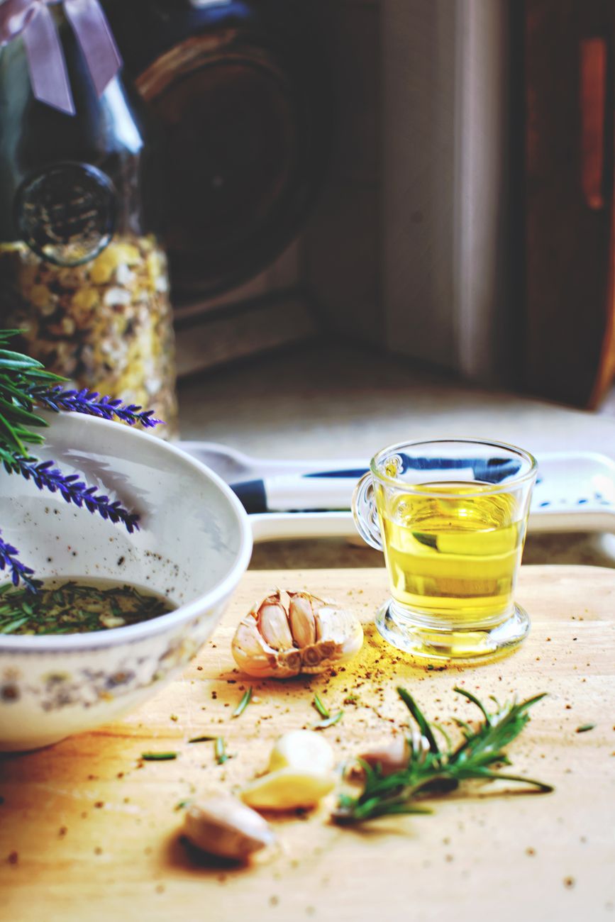 Wild herbs and olive oil in hand-crafted ceramic bowl